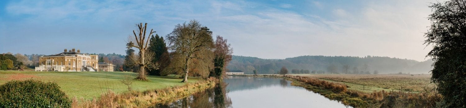 River and old house on bank in the distance.