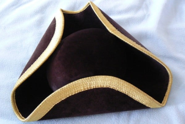 Black tricorn hat with gold edging.