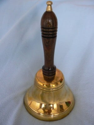Brass bell with wooden handle.