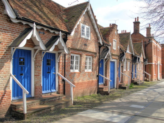 Blue front doors. Brick houses with white window frames.