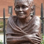 Head and shoulders of bronze statue. Boy swimmer.