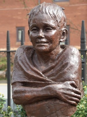 Head and shoulders of bronze statue. Boy swimmer.