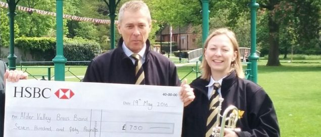 Hand over of a large cheque to brass band members.