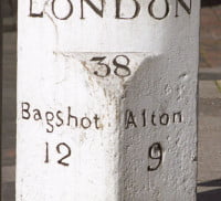 White distance stone showing distance to London, Bagshot and Alton.