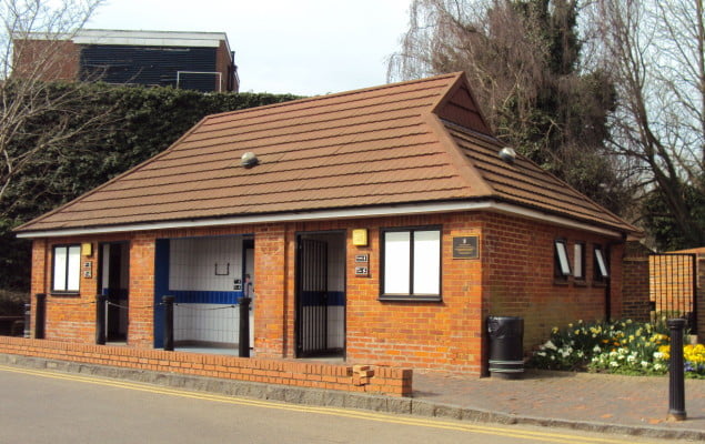 Outside toilet building. Flowers to right hand side.