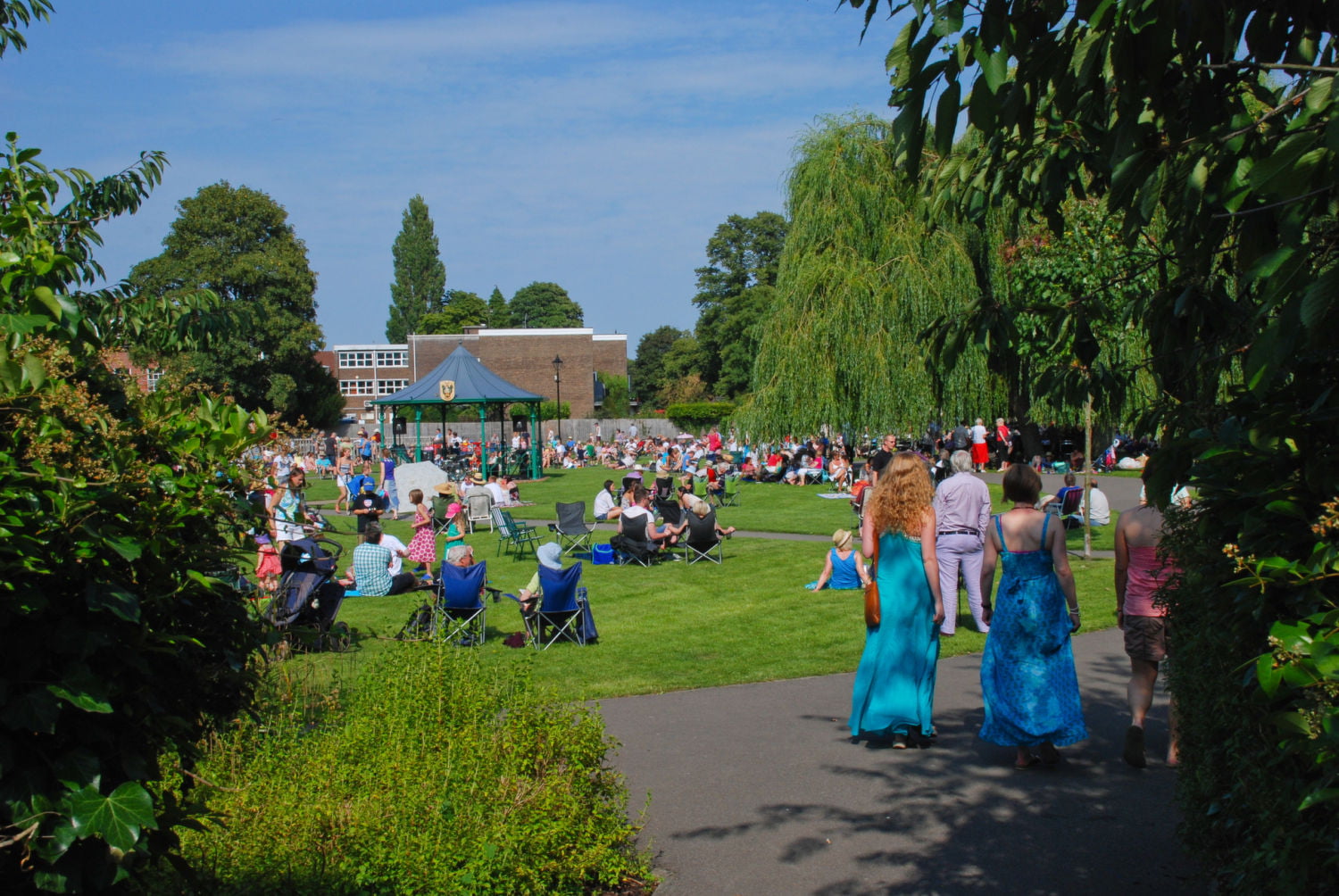 people sitting in park, bandstand