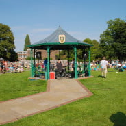 Bandstand, with crowd behind. Band playing inside.