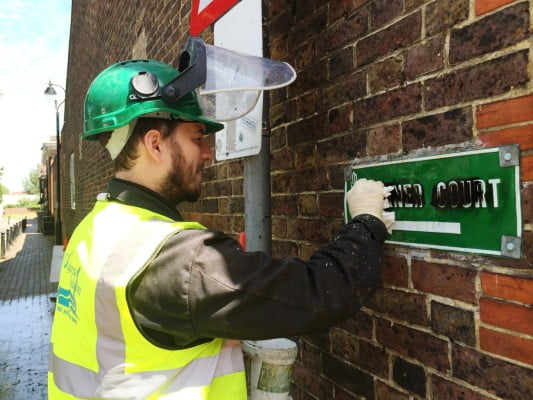 Man removing graffiti