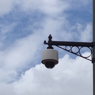 CCTV camera on decorative bracket. Blue sky and white clouds. © Farnham Town Council