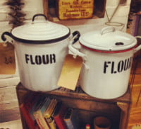 Two white jars with black writing.