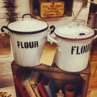 Two white jars with black writing.