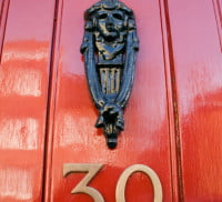 Red front door, door knocker, no 30.