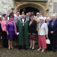 Group of males and females outside church.