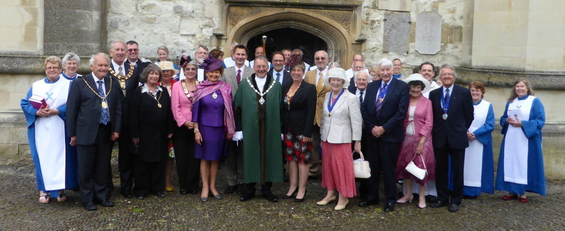 Group of males and females outside church.