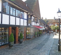 Cobbled street with shops either side