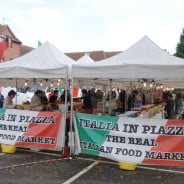 Red, green and white, Italia in Piazza banners on side of market stalls.