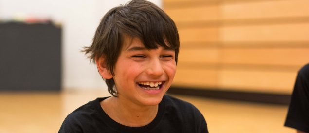 Close up of a happy smiling boy wearing a black t-shirt