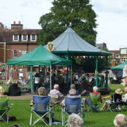 People, bandstand, music in the meadow.