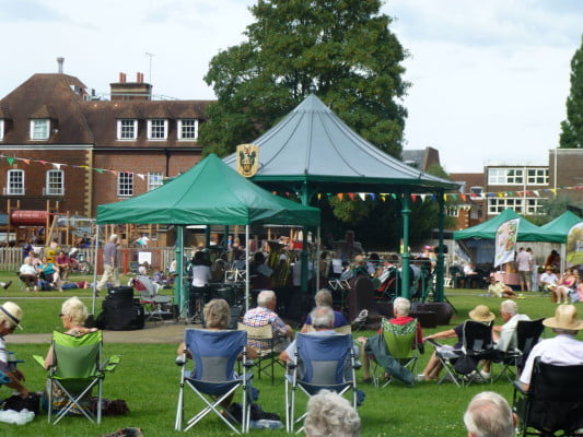 People, bandstand, music in the meadow.