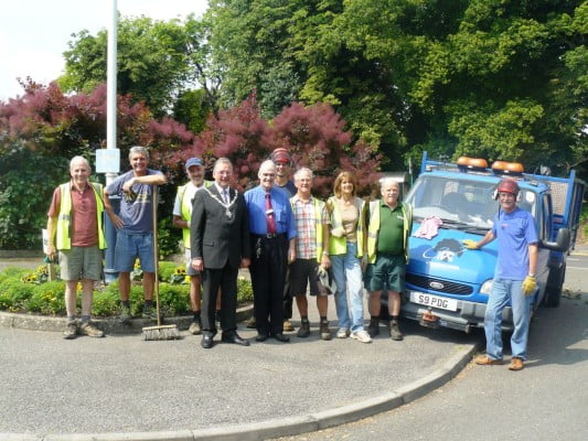 People next to a blue van