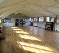 Inside village hall. Wooden floor. Spacious hall.