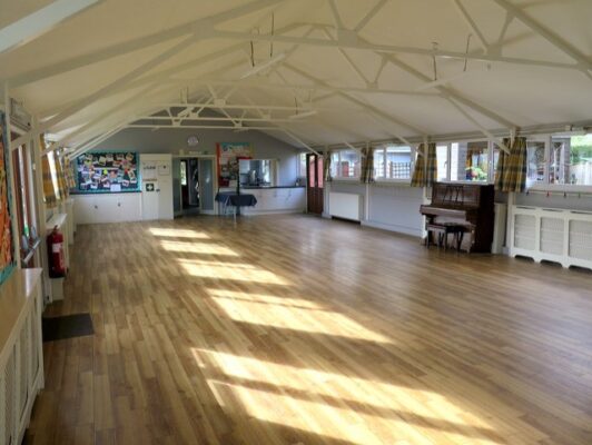 Inside village hall. Wooden floor. Spacious hall.