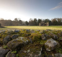 Abbey ruins on green open space. Open countryside and blue sky