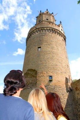 Tall stone round tower, three people, Andernach