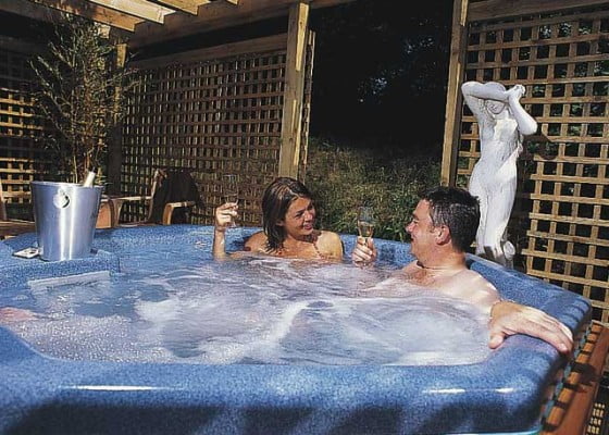 Male and Female in blue hot tub