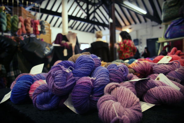 purple knitted products on black table.