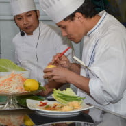 two males in chef whites cooking