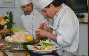 two males in chef whites cooking