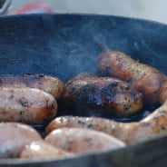 Cooking sausages. Frying pan.