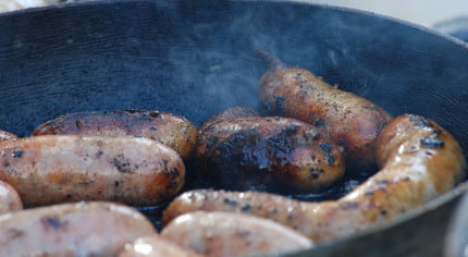 Cooking sausages. Frying pan.