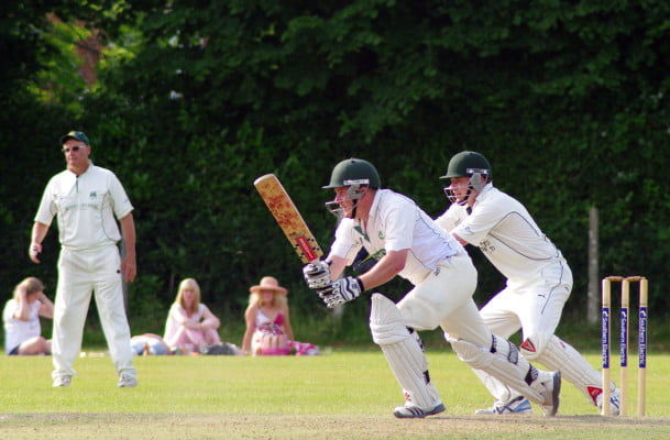 3 males playing cricket