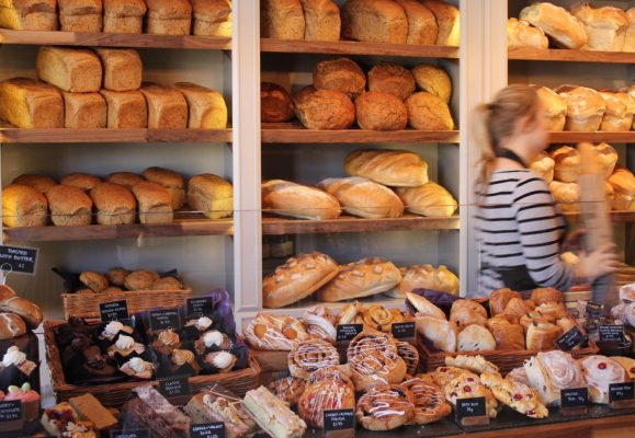 Loaves of bread and cakes inside a bakery.