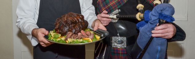 Chef holding venison joint on silver tray and piper holding bag pipes.