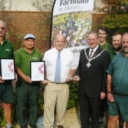 Seven men including Mayor, holding certificates and trophy for Farnham in Bloom.