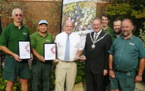 Seven men including Mayor, holding certificates and trophy for Farnham in Bloom.