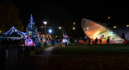 Park at night, with a stage, christmas lights and christmas tree