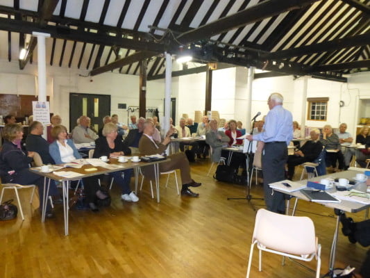 group of people listening to a presentation.