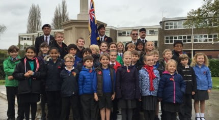 School children, standard bearer, war memorial, Armistice Day 2014.