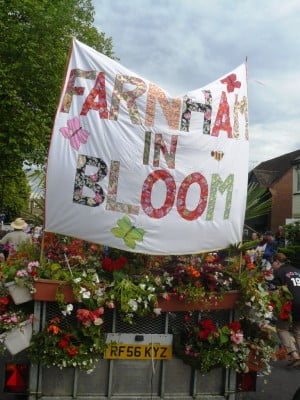 Trailer, Farnham in Bloom banner, flowers on trailer. Carnival float.