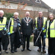 4 males and 1 female with black rubbish sacks and litter pickers.