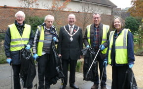 4 males and 1 female with black rubbish sacks and litter pickers.