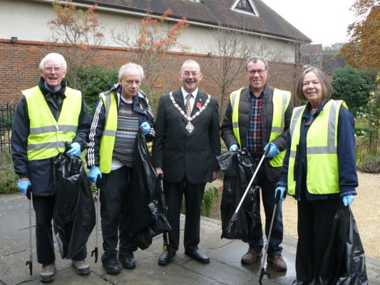 4 males and 1 female with black rubbish sacks and litter pickers.