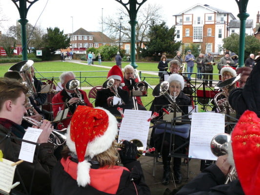 The Farnham Brass Band playing in the bandstand in Gostrey Meadow.