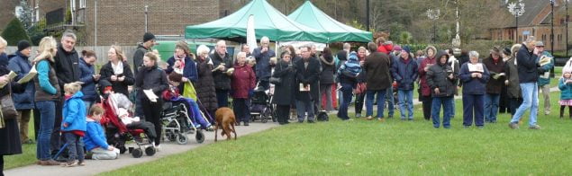 Crowd of people singing carols in Gostrey Meadow