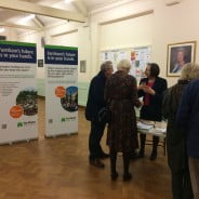 People talking and looking at exhibition.