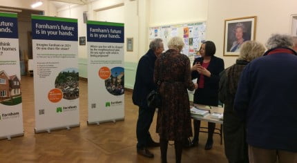 People talking and looking at exhibition.